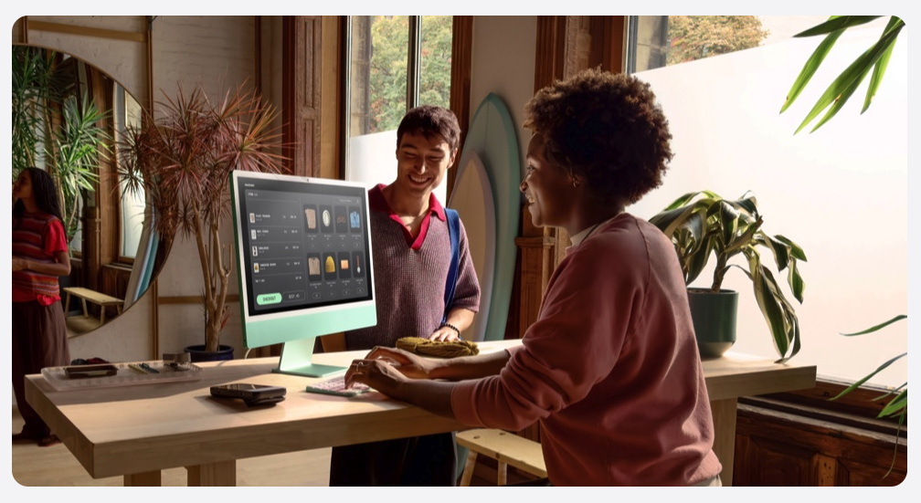 Small business owner using an iMac managed through Apple Business